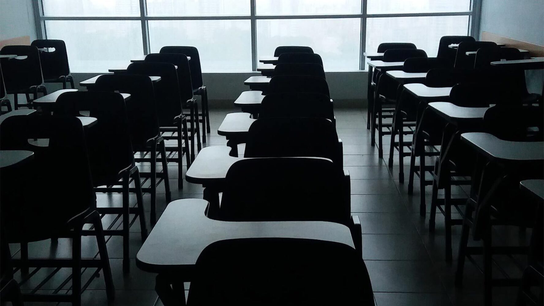 Rows of tables in an empty classroom