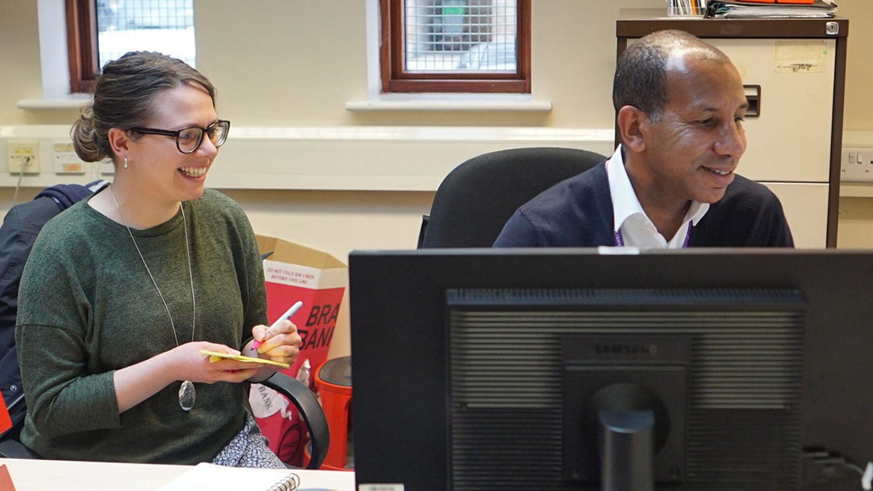 Two people working at a computer